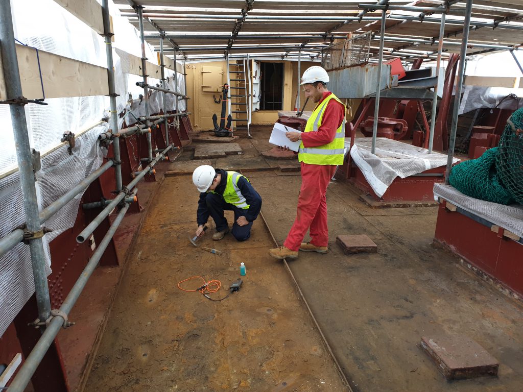Workers from Beckett Rankine inspect the steel deck