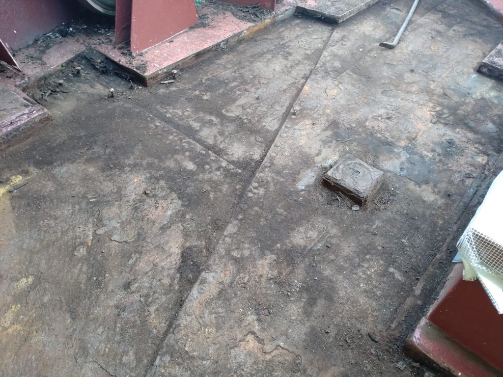 A section of the starboard side foredeck, revealing the riveted plate steel deck from beneath the timber for the first time since 1956.